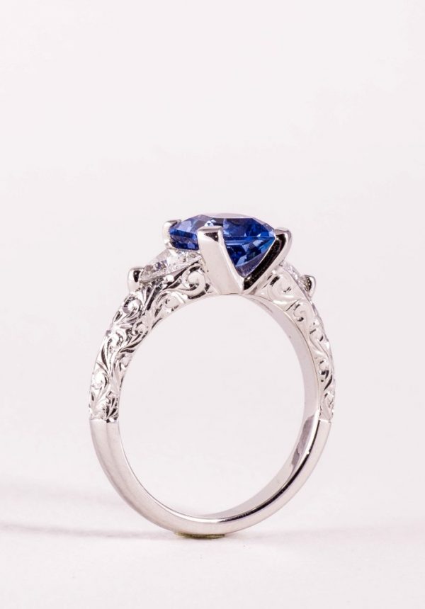 Sapphire and diamond three stone ring with hand engraving